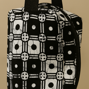 Toiletry bag in black background with white geometric patterns