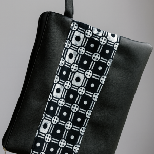 Zipper pouch in Black bag with a black-and-white geometric print