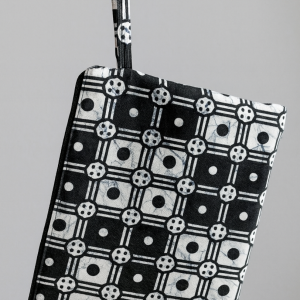 Zipper pouch in black background with white geometric patterns
